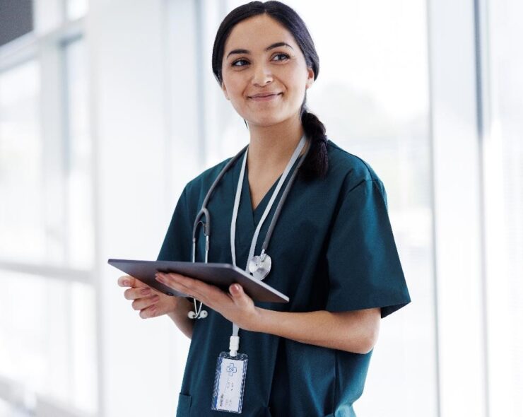 Female doctor in hospital looking at digital tablet