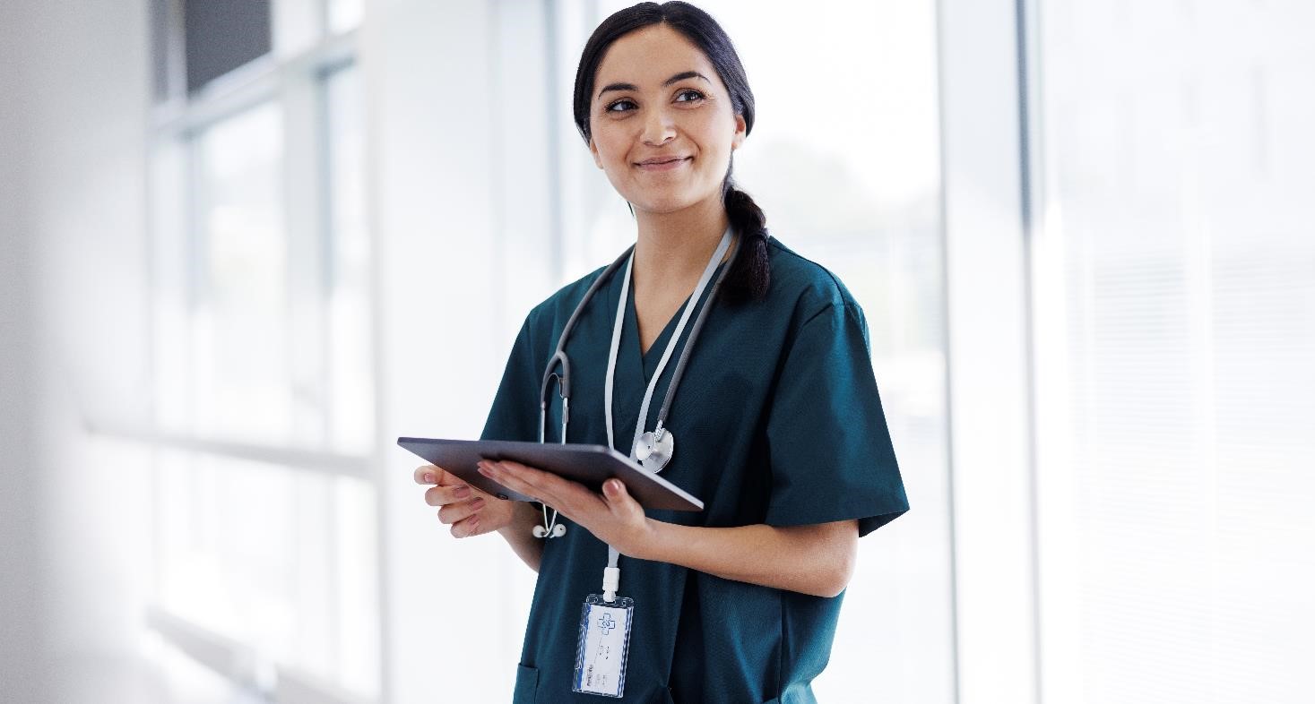 Female doctor in hospital looking at digital tablet