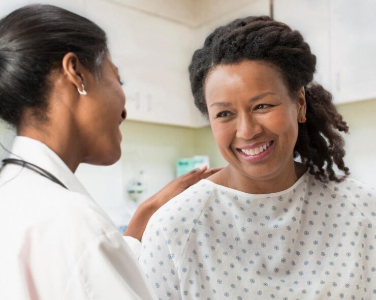 Doctor comforting patient in office