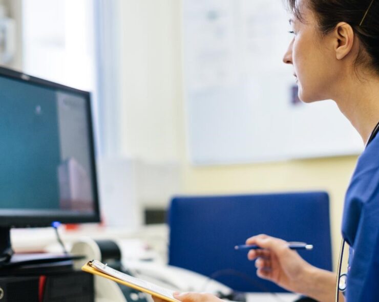 Female doctor sitting in her office and working on a computer