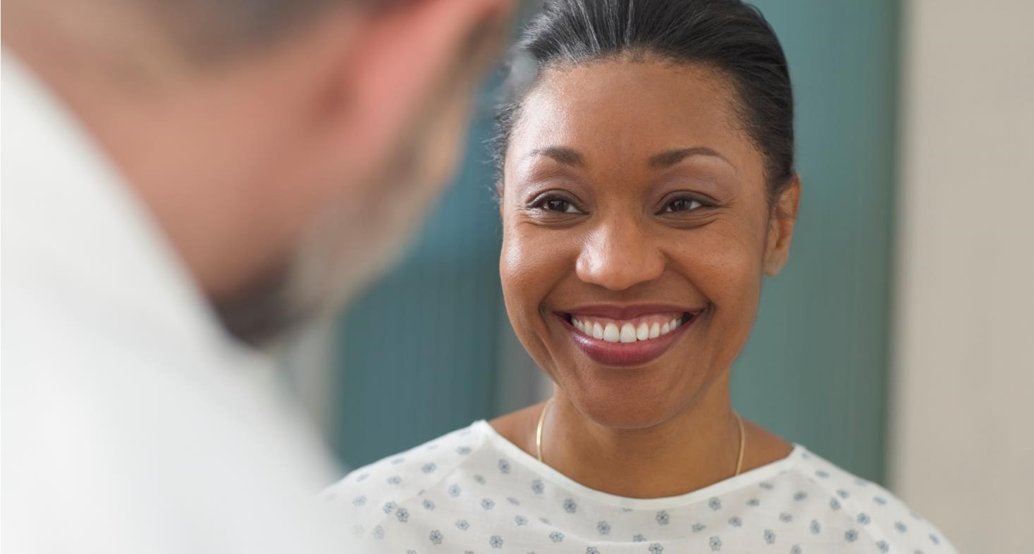 Female patient smiling at her physician