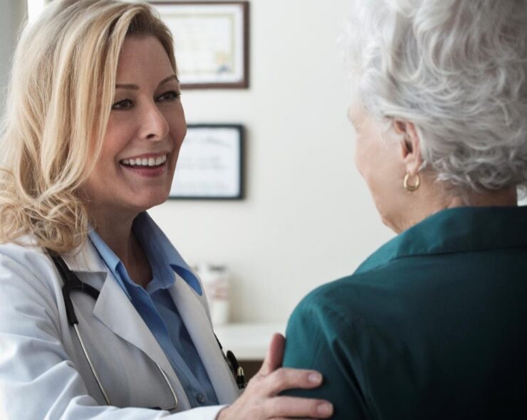 Female doctor talking to a senior patient in clinic